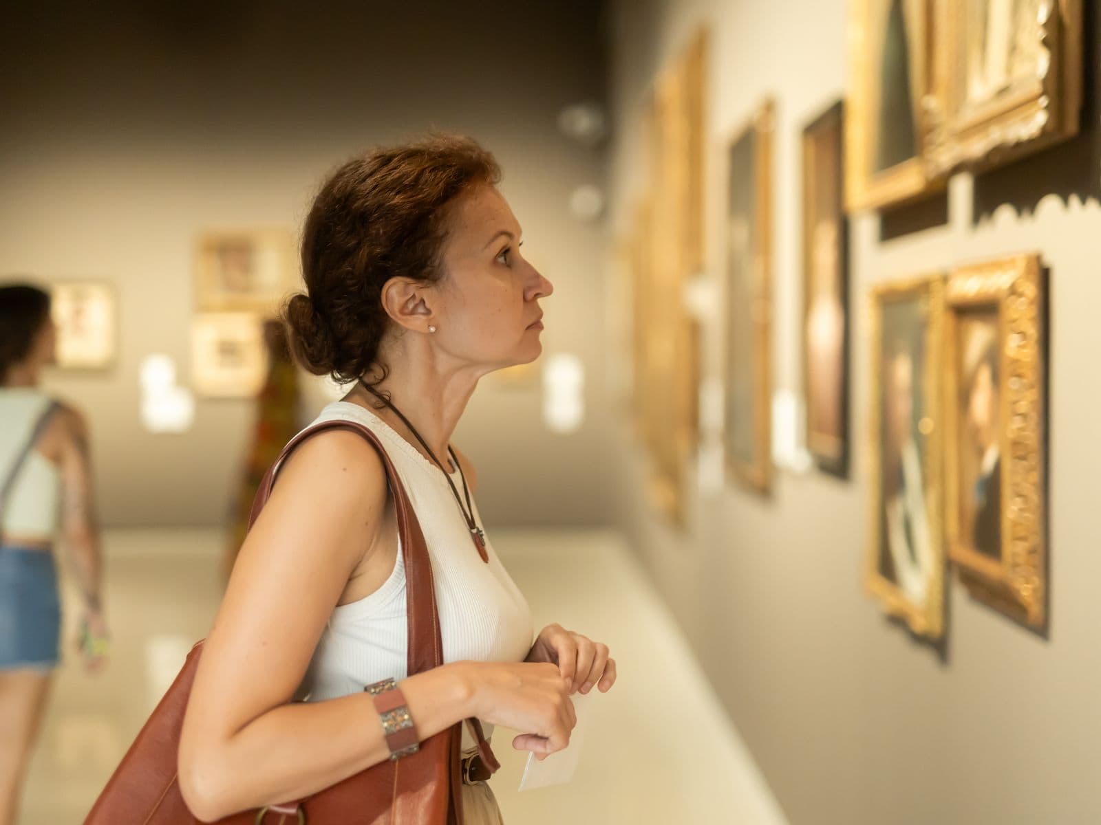 Collector considering a work in a gallery